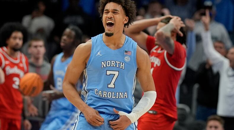 North Carolina guard Seth Trimble (7) celebrates a win against Ohio State after an NCAA basketball game, Saturday, Dec. 20, 2025, in Atlanta. (AP Photo/Mike Stewart)