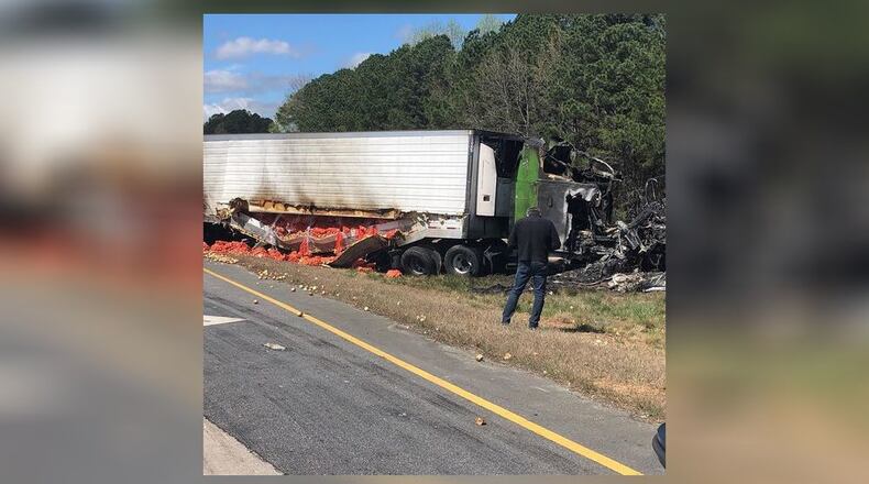 A busy Gwinnett County road was shut down for hours Saturday after a tractor-trailer carrying a load of Vidalia onions crashed into another truck and caught fire, police said.