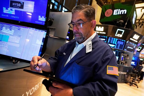 Trader Robert Oswald works on the floor of the New York Stock Exchange, Wednesday, April 23, 2025. (AP Photo/Richard Drew)