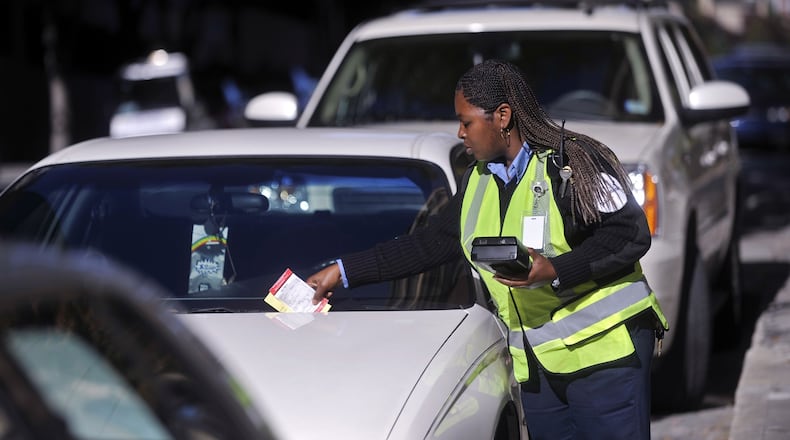 Fines can range from $50 to $200 for parking meter violations or $75 for booting. AJC file photo