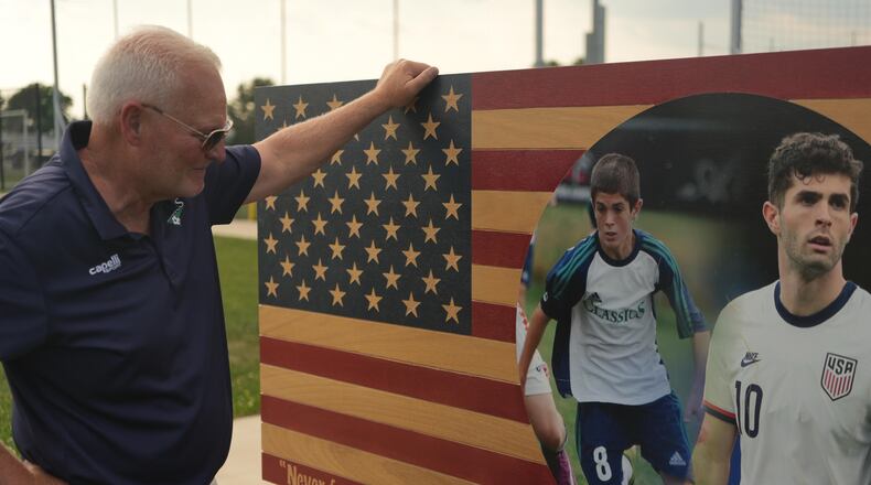 Pennsylvania Classic co-founder and president, Doug Harris, looks at a banner of U.S. national team soccer player, Christian Pulisic, who was born in nearby Hershey, and honed his skills at the club in Manheim, Pa., on Monday, June 29, 2026. (AP Photo/Luis Andres Henao)