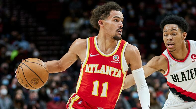 Hawks guard Trae Young dribbles against the defense of Blazers guard Anfernee Simons during the first half of Monday's game in Portland. (AP Photo/Craig Mitchelldyer)