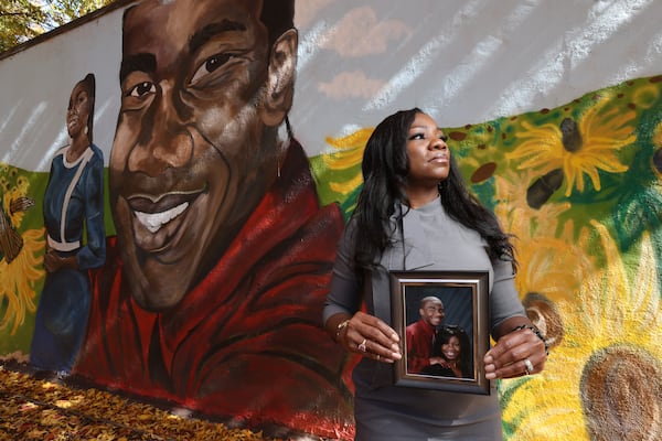 Monteria Robinson, the mother of Jamarion Robinson, poses in front of a mural dedicated to her son’s memory on Wednesday, November 10, 2021. Miguel Martinez for The Atlanta Journal-Constitution 