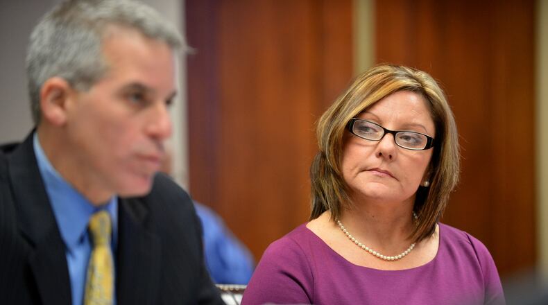 Cherokee school board member Kelly Marlow listens to her defense attorney Brian Steel present her case during a hearing Thursday, November 14, 2013, before a panel appointed by the governor to convince them not to remove her from office while her criminal proceedings move forward.