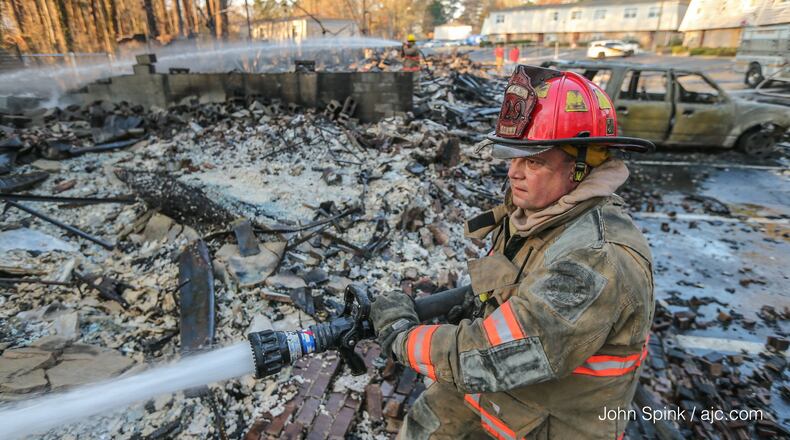 Firefighters were putting out the final hot spots after a blaze destroyed 20 units at a Clayton County apartment complex and displaced 65 people.