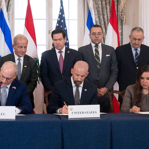 Secretary of State Marco Rubio and others watch, seated from left, Israel's Ambassador to the U.S. Yechiel Leiter, counselor Dan Holler, and Lebanon's Ambassador to the U.S. Nada Hamadeh, sign a framework agreement, described as a first step toward peace following months of conflict between Israel and the Lebanese militant group Hezbollah, at the State Department, Friday, June 26, 2026, in Washington. (AP Photo/Kevin Wolf)