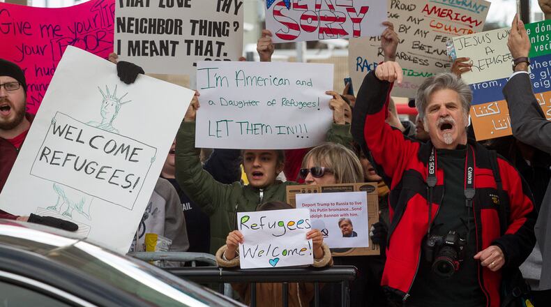 Protesters hold up signs during a demonstration against President Trump's recent travel ban on Sunday at Hartsfield-Jackson Atlanta International Airport. Steve Schaefer/Special to the AJC
