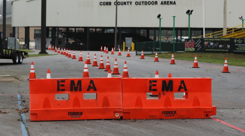 March 17, 2020 Marietta: Health department officials are setting up for the drive-thru testing of coronavirus in Jim Miller Park at the Cobb County Outdoor Arena on Tuesday, March 17, 2020, in Marietta. Curtis Compton ccompton@ajc.com