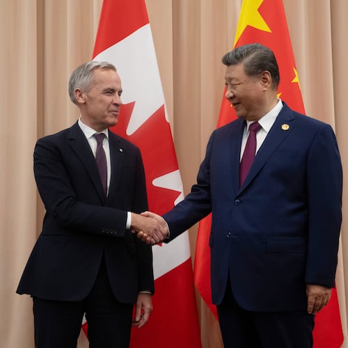 FILE - Canadian Prime Minister Mark Carney, left, shakes hands with Chinese President Xi Jinping at the start of a meeting in Gyeongju, South Korea, Oct. 31, 2025. (Adrian Wyld/The Canadian Press via AP, File)