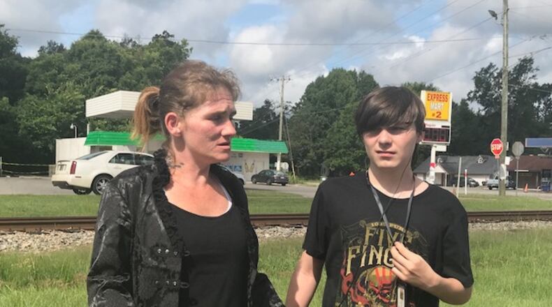 Suzeanna Brill is reunited with her son, Matthew Ray, after a court hearing where she regained custody. The 15-year-old was removed from Brill's home after authorities learned she had been allowing him to treat seizures by smoking marijuana. Photo: Christian Boone/AJC
