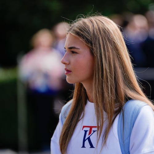 FILE - Kai Trump watches as her grandfather President Donald Trump speaks to reporters before departing the White House, Sept. 26, 2025, in Washington. (AP Photo/Julia Demaree Nikhinson, file)