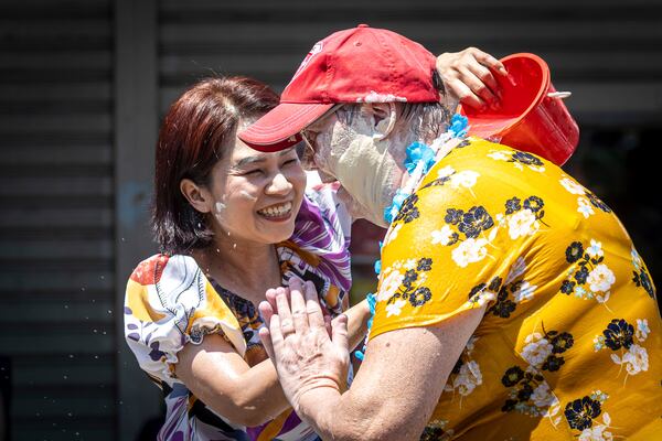 Thai woman is drenched in water to foreigner during the Songkran water festival to celebrate the Thai New Year in Prachinburi Province, Thailand, Sunday, April 13, 2025. (AP Photo/Wason Wanichakorn)