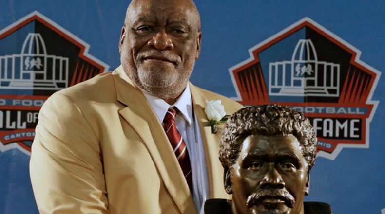 Hall of Fame Inductee Claude Humphrey poses with his bust during the 2014 Pro Football Hall of Fame Enshrinement Ceremony at the Pro Football Hall of Fame Saturday, Aug. 2, 2014, in Canton, Ohio. (AP Photo/Tony Dejak)