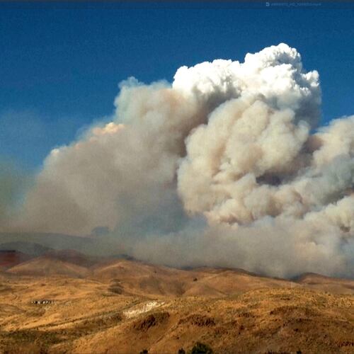 This image taken from video shows plumes of smoke rising from active wildfires Saturday, Aug. 22, 2026, in Reno, Nevada. (Tim Walton via AP)