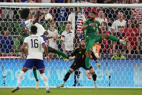 Saudi Arabia's Nawaf Alaqidi (1) and Abdulelah Alamri (4) look to block a shot by United States' Chris Richards, left, during a CONCACAF Gold Cup soccer match, Thursday, June 19, 2025, in Austin, Texas. (AP Photo/Eric Gay)