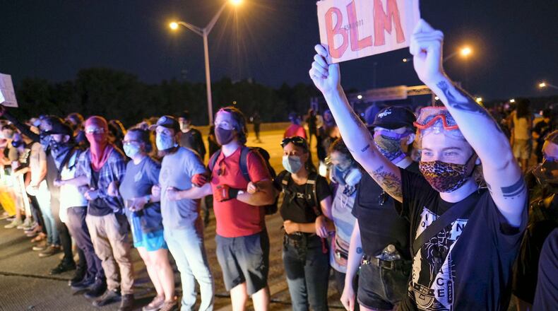 Demonstrators get on to I-75 and shut down the interstate Saturday night.  Throughout the day, protesters gathered at the Wendy's where Rayshard Brooks, a 27-year-old black man,  was shot and killed by Atlanta police the night before.    Ben Gray for the Atlanta Journal Constitution