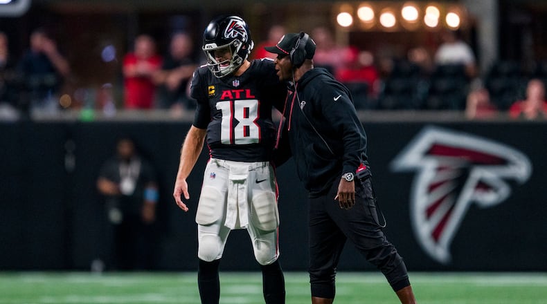 Atlanta Falcons head coach Raheem Morris talks with quarterback Kirk Cousins (18) during the second half of an NFL football game against the Kansas City Chiefs, Sunday, Sept. 22, 2024, in Atlanta. The Chiefs defeated the Falcons 22-17. (AP Photo/Danny Karnik)