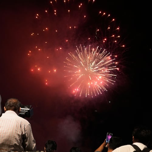 People watch fireworks in Lahore, Pakistan, Saturday, Aug. 8, 2026, during celebrations of the signing a trilateral defense agreement between Saudi Arabia, Pakistan and Turkey in Mecca. (AP Photo/K.M. Chaudary)
