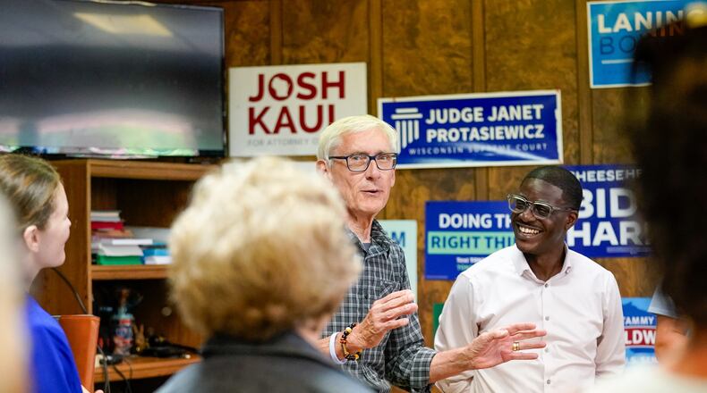 Wisconsin Gov. Tony Evers, center left, speaks in support of David Crowley, right, Democratic candidate for Wisconsin governor while campaigning at the Sheboygan County Democratic Party Friday, Aug. 7, 2026, in Sheboygan, Wis. (AP Photo/Kayla Wolf)