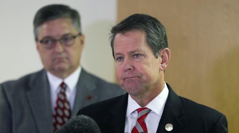 Georgia Secretary of State Brian Kemp (right) and Russell Lewis, chief investigator with the Secretary of State’s Office, spoke at a press conference. Kemp was a recipient of a letter from the ACLU questioning a letter that was sent by Fulton County. BOB ANDRES /BANDRES@AJC.COM AJC FILE PHOTO