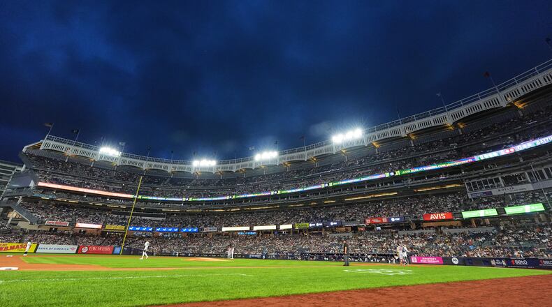 Play is stopped after lights lost power during the first inning of a baseball game between the New York Yankees and the St. Louis Cardinals Wednesday, Aug. 5, 2026, in New York. (AP Photo/Frank Franklin II)