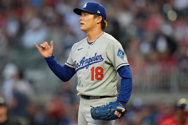 Los Angeles Dodgers pitcher Yoshinobu Yamamoto (18) reacts in the fourth inning of a baseball game against the Atlanta Braves, Friday, May 2, 2025, in Atlanta. (AP Photo/Mike Stewart)