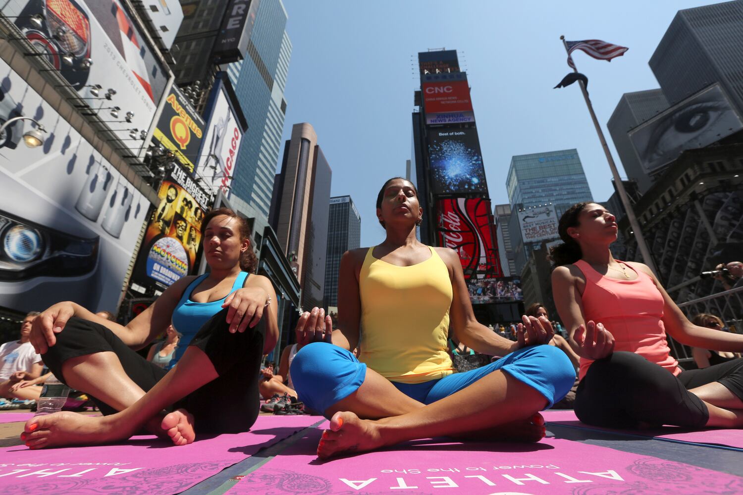 Enthusiasts perform yoga in Times Square to mark summer solstice, June 21, 2013