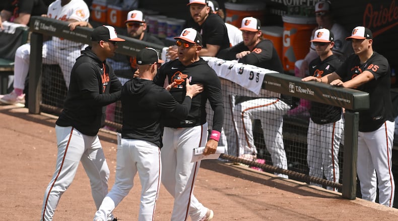 Baltimore Orioles' infield coach Miguel Cairo, center, argues after being ejected from a baseball game against the Athletics, Sunday, May 10, 2026, in Baltimore. (AP Photo/Steve Ruark)