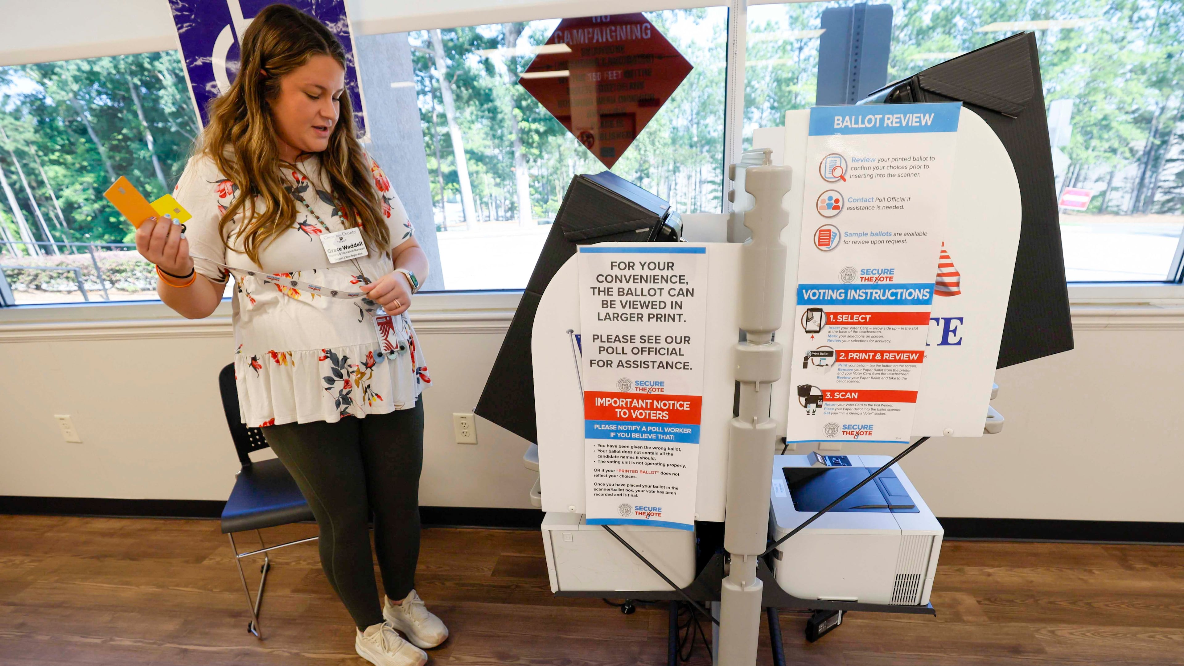 Grace Waddell, a training and elections manager, checks a voting machine at the Cherokee County elections office during the runoff election for Public Service Commission on Tuesday, July 8, 2025. (Miguel Martinez/AJC)