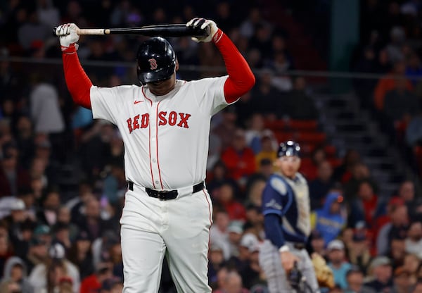 Boston Red Sox designated hitter Rafael Devers reacts after striking out as Tampa Bay Rays catcher Danny Jansen looks on during the seventh inning of a baseball game at Fenway Park, Monday, June 9, 2025, in Boston. (AP Photo/Mary Schwalm)