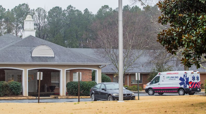 An ambulance delivers a patient to the Rosemont at Stone Mountain senior living facility on Thursday. On one day in January, Rosemont reported 21 COVID-19 deaths to the state’s daily public case-tracker. (Jenni Girtman for The Atlanta Journal-Constitution)