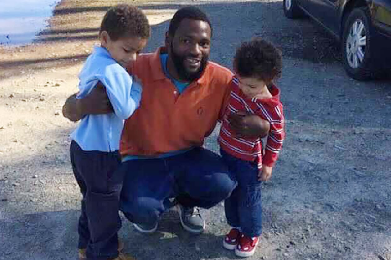 In this 2015 family photo, Antonio May poses with his sons Za'Kobe and Jordan Rickerson. In September 2018, May was pronounced dead after being repeatedly shocked with a Taser in the Fulton County Jail. (Courtesy of May attorney Michael Harper)
