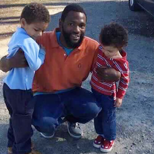In this 2015 family photo, Antonio May poses with his sons Za'Kobe and Jordan Rickerson. In September 2018, May was pronounced dead after being repeatedly shocked with a Taser in the Fulton County Jail. (Courtesy of May attorney Michael Harper)