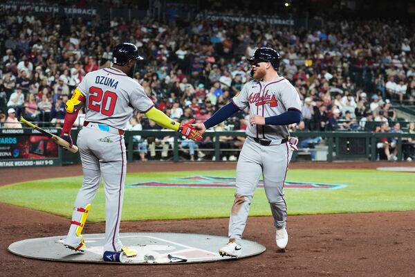 Braves outfielder Alex Verdugo (right) celebrates his run scored against the Arizona Diamondbacks with Marcell Ozuna during the second inning of Friday's baseball game in Phoenix. (Ross D. Franklin/AP)