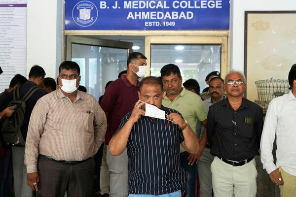 Relatives of the victims, who died in the Air India plane crash, wait outside the DNA collection center at a hospital in Ahmedabad, India, Saturday, June 14, 2025. (AP Photo/Rafiq Maqbool)