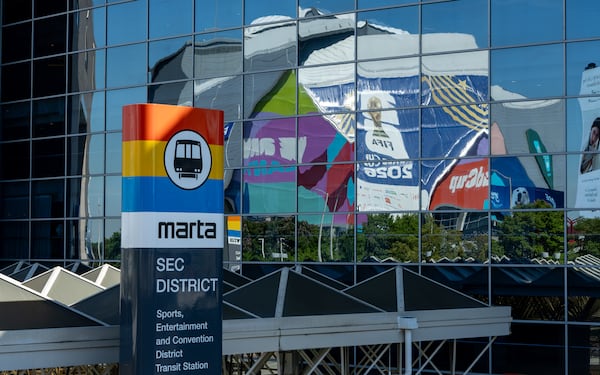 The Mercedes-Benz Statidum (Atlanta Stadium during the World Cup) is reflected in glass outside the SEC District MARTA station on Thursday, June 4, 2026. (Ben Hendren for the AJC)