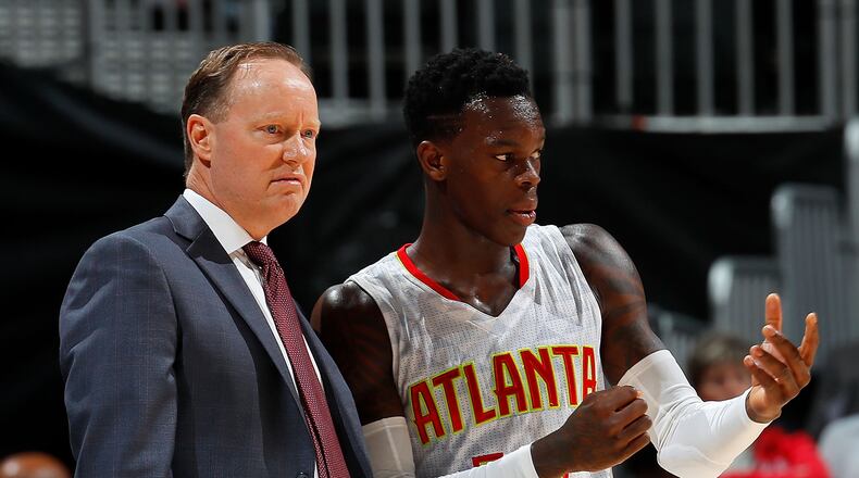 Hawks coach Mike Budenholzer instructs point guard Dennis Schroder during a preseason game this month. (Photo by Kevin C. Cox/Getty Images)