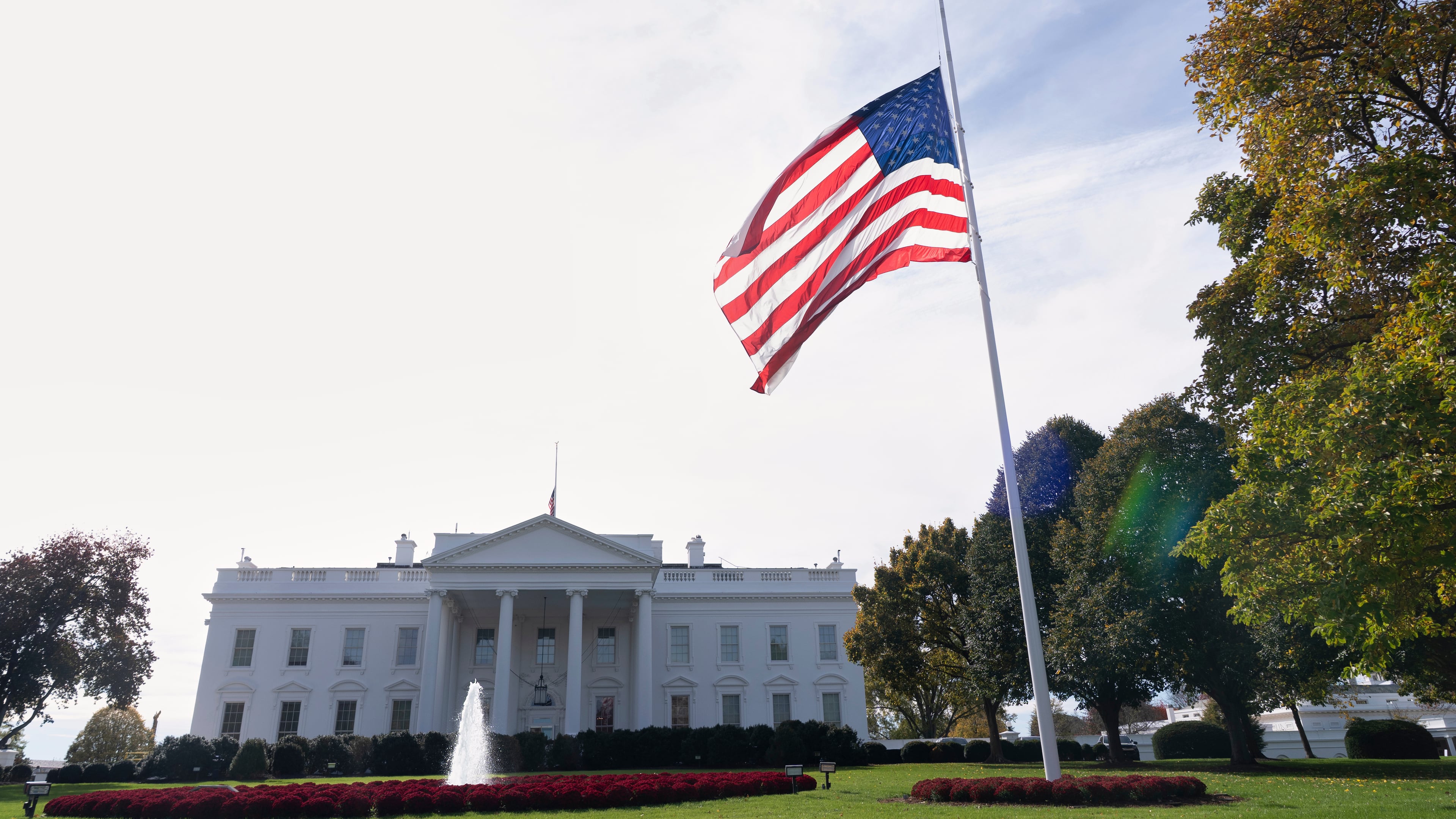 The American flag is seen at half-staff, Tuesday, Nov. 4, 2025, at the White House in Washington. (AP Photo/Manuel Balce Ceneta)