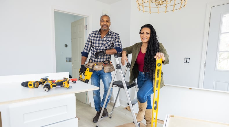 As seen on "Married to Real Estate," hosts Mike Jackson and Egypt Sherrod work together to finish cabinets and design elements in a completely renovated kitchen for a homeowner.