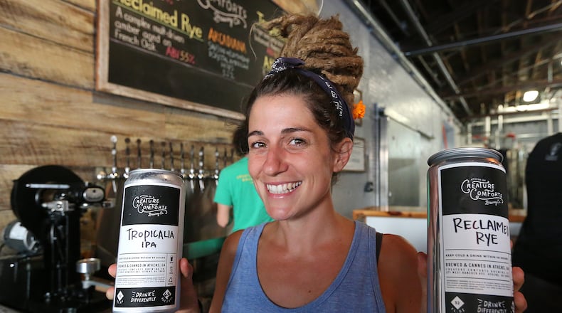 082715 ATHENS: Tour staff employee Sara Fleetwood serves up two 32 ounce crowlers to go at the Creature Comforts Brewing Company on Thursday, August 27, 2015, in Athens. Curtis Compton / ccompton@ajc.com