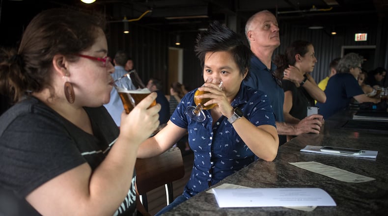 Kristi Tanner (left) and Avery Le enjoy a beer on the rooftop bar at New Realm Brewing in Atlanta last June.