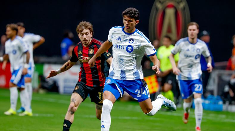 CF Montreal defender Efrain Morales (24) controls the ball against Atlanta United forward Saba Lobjanidze, center left, during the first half of an MLS soccer match, Saturday, May 2, 2026, in Atlanta. (AP Photo/Erik S. Lesser)