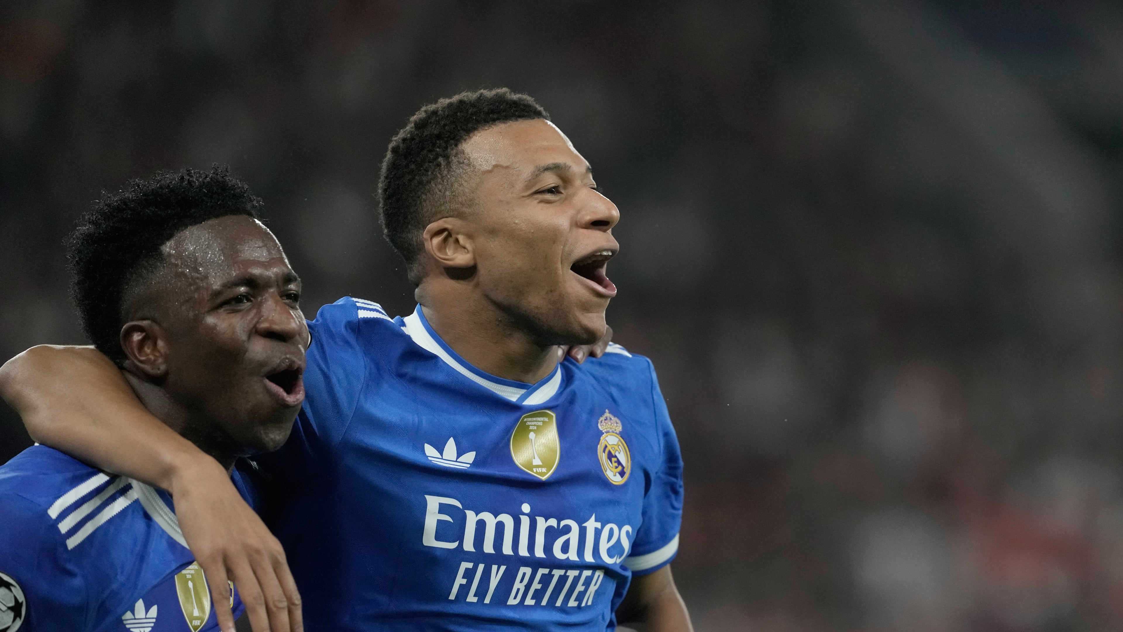 Real Madrid's Kylian Mbappe, right, celebrates with his teammate Vinicius Junior after scoring his side's fourth goal during the Champions League opening phase soccer match between Olympiacos and Real Madrid, in in Piraeus port, near Athens, Greece, Wednesday, Nov. 26, 2025. (AP Photo/Petros Giannakouris)
