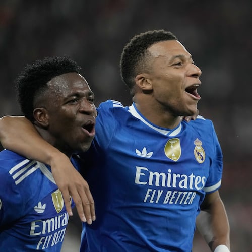 Real Madrid's Kylian Mbappe, right, celebrates with his teammate Vinicius Junior after scoring his side's fourth goal during the Champions League opening phase soccer match between Olympiacos and Real Madrid, in in Piraeus port, near Athens, Greece, Wednesday, Nov. 26, 2025. (AP Photo/Petros Giannakouris)