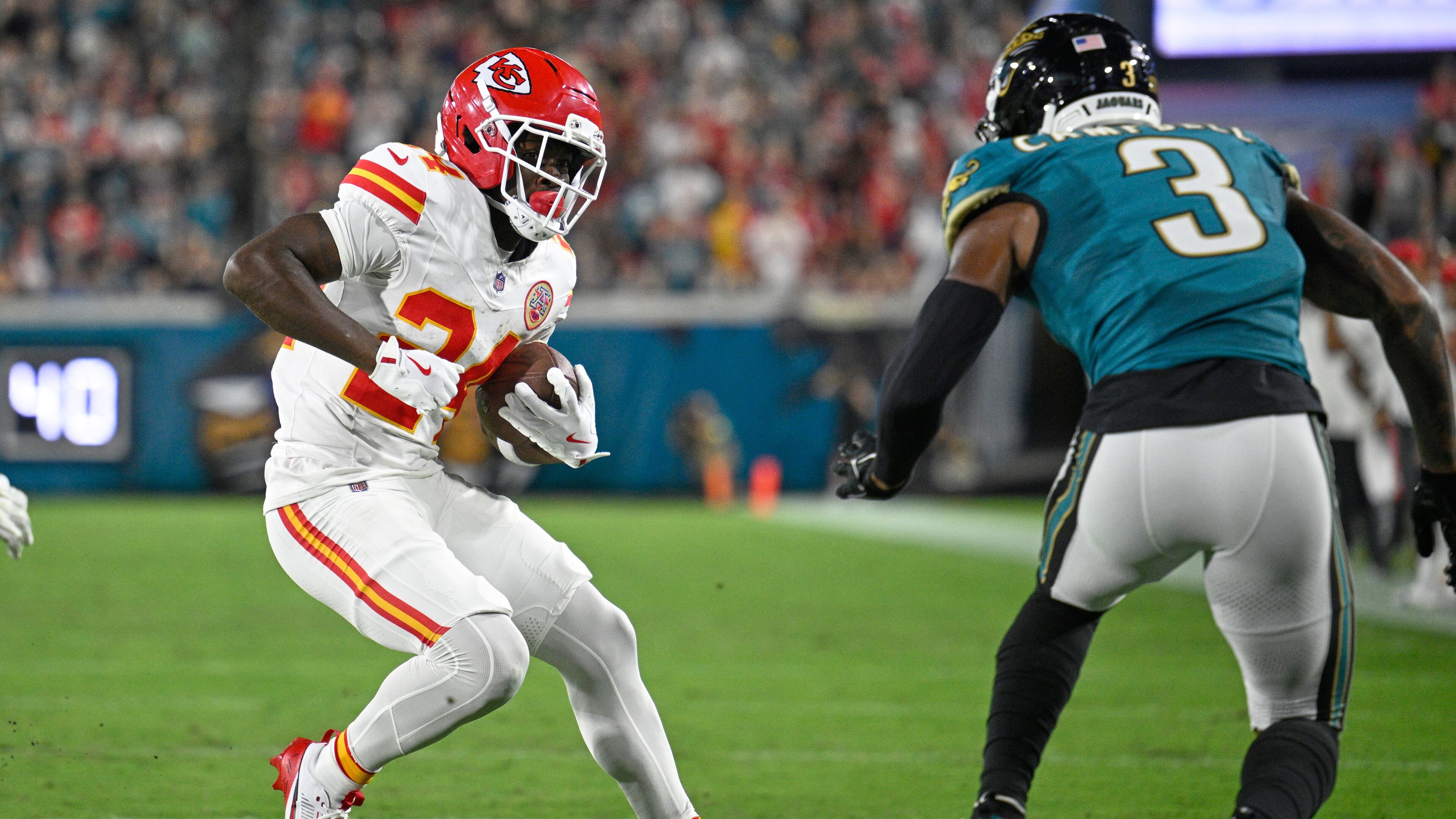 Kansas City Chiefs running back Brashard Smith (24) runs the ball under pressure from Jacksonville Jaguars cornerback Tyson Campbell (3) during the first half of an NFL football game, Monday, Oct. 6, 2025, in Jacksonville, Fla. (AP Photo/Phelan M. Ebenhack)