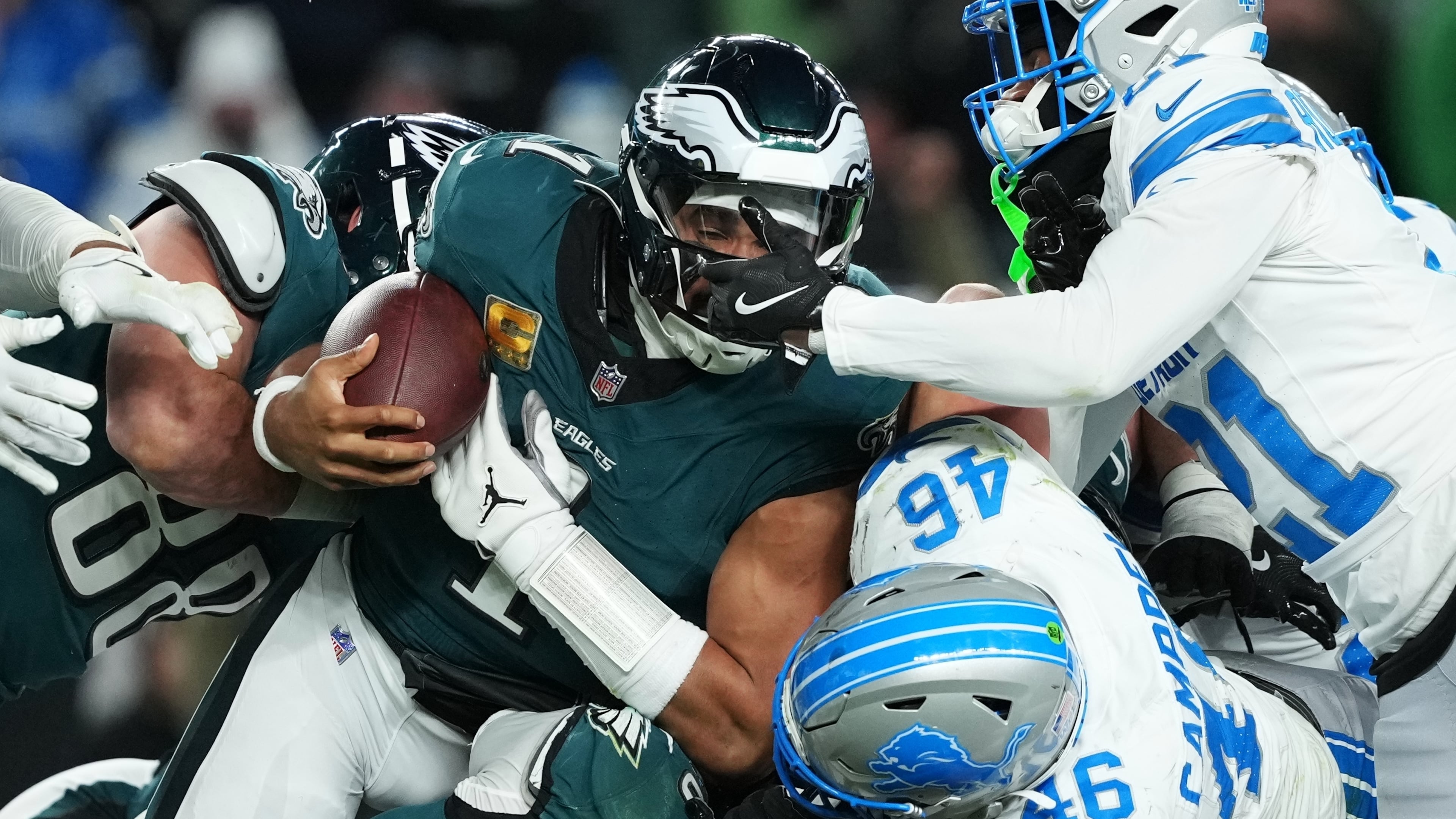 Philadelphia Eagles quarterback Jalen Hurts (1) is stopped with the ball during the second half of an NFL football game by Detroit Lions linebacker Jack Campbell (46) and Lions cornerback Amik Robertson (21) Sunday, Nov. 16, 2025, in Philadelphia. (AP Photo/Matt Slocum)