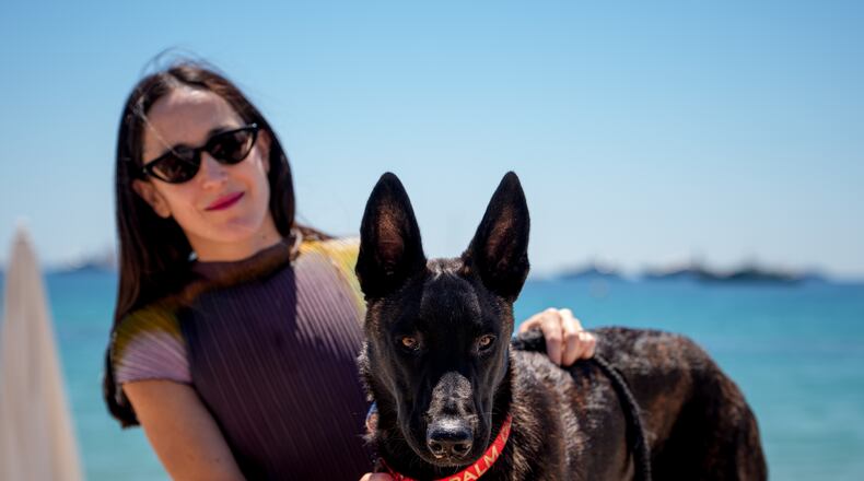 Dominga Sotomayor, left, director of the film "La Perra" poses with Apocalypse after accepting the palm dog award on behalf of Yuri, who could not attend, at the end the Palm Dog award ceremony at the 79th international film festival, Cannes, southern France, Friday, May 22, 2026. (AP Photo/Andreea Alexandru)