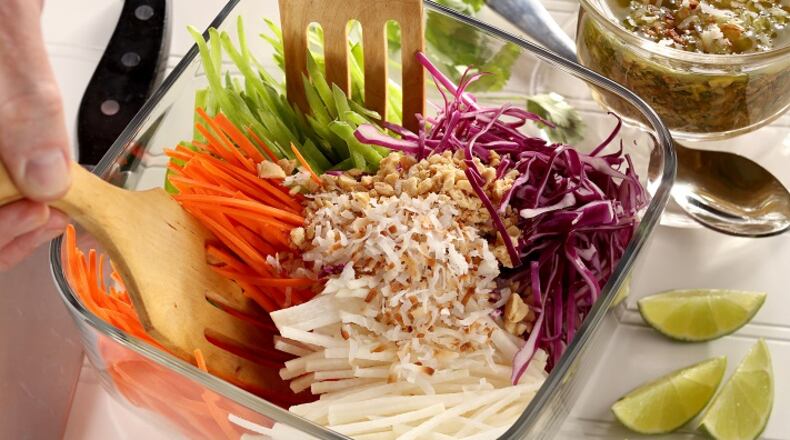 An Indian-style slaw features finely julienned carrots, pea pods, cabbage and jicama, garnished with shredded coconut, peanuts and cilantro. (Food styling by Mark Graham.) (Michael Tercha/Chicago Tribune/TNS)