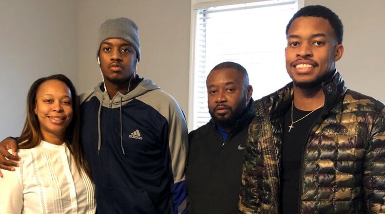 Christion Abercrombie, second from left, was able to leave the Shepherd Center over the weekend to visit his family at home.