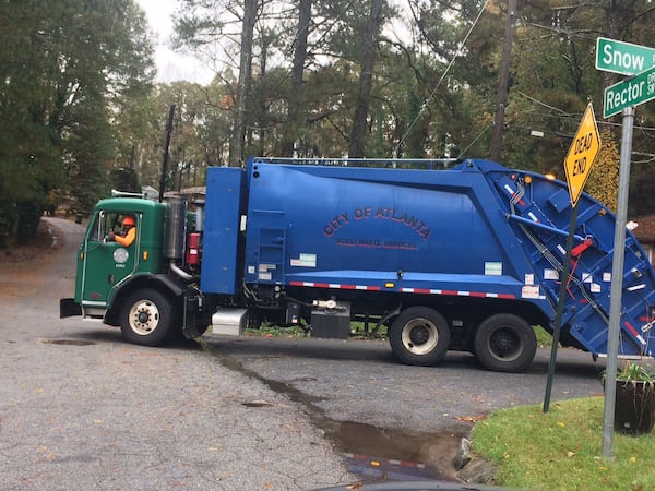 A city of Atlanta employee driving a city waste collection truck during his route. Photo by Bill Torpy